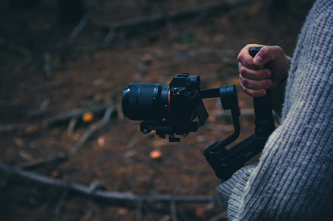 Camera operator filming with a professional video camera
